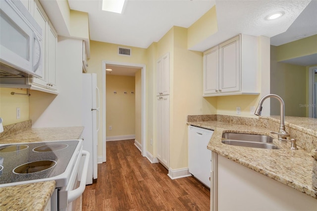 kitchen with white cabinetry, dark hardwood / wood-style flooring, white appliances, and sink