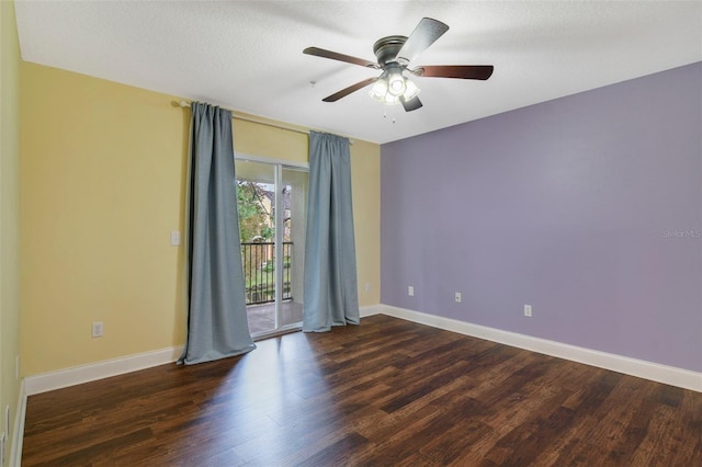 unfurnished room with ceiling fan, dark wood-type flooring, and a textured ceiling