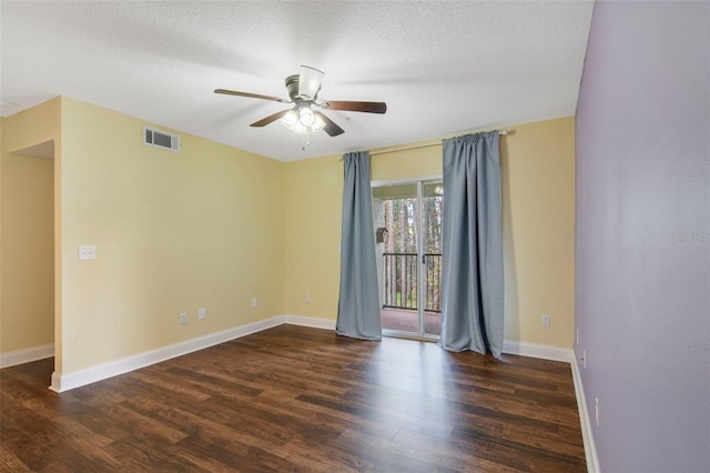 empty room with a textured ceiling, ceiling fan, and dark hardwood / wood-style floors