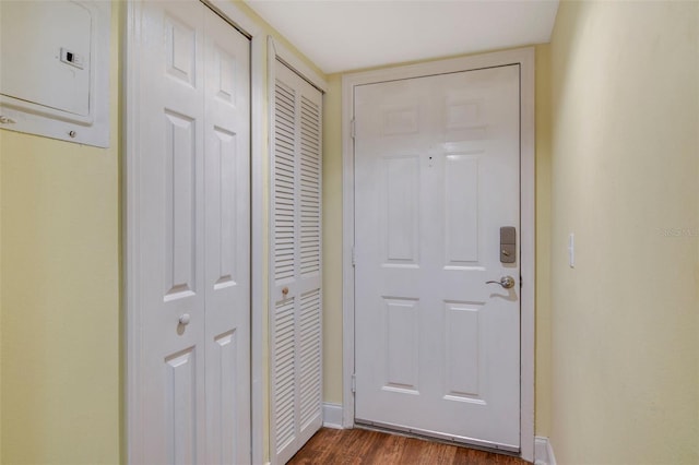 doorway to outside featuring dark wood-type flooring and electric panel