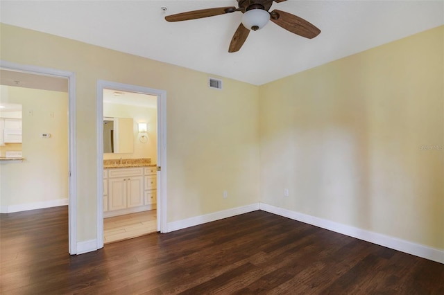 spare room featuring ceiling fan, dark hardwood / wood-style flooring, and sink