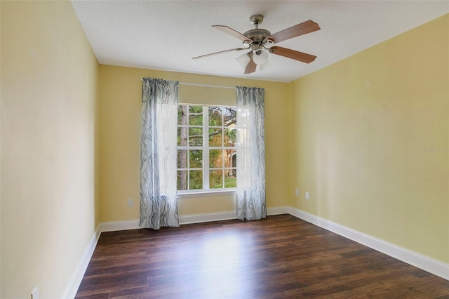 spare room with ceiling fan and dark wood-type flooring