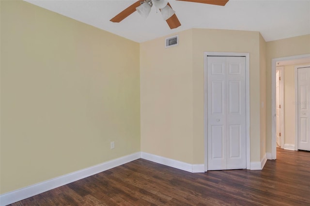 unfurnished bedroom featuring ceiling fan, dark hardwood / wood-style floors, and a closet