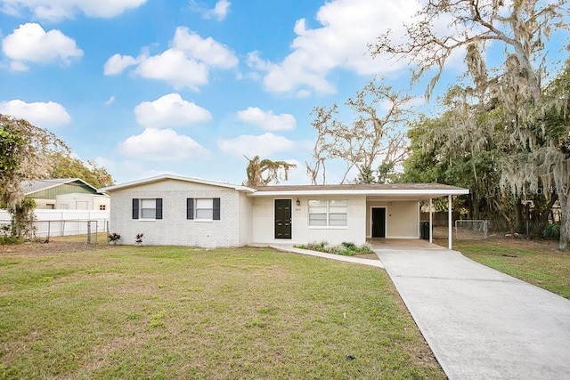 view of front facade with a front yard and a carport