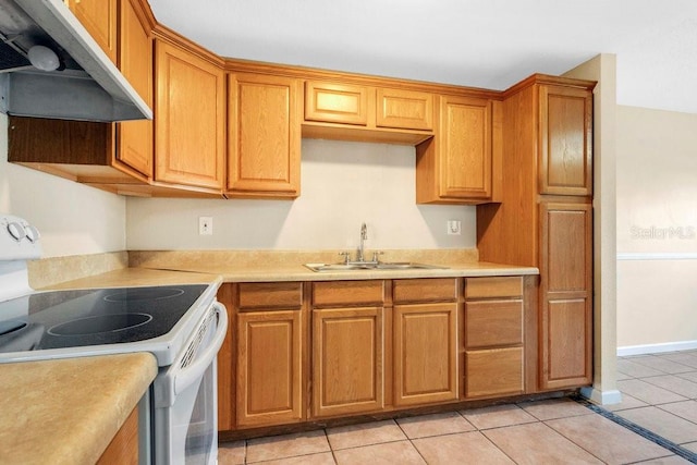 kitchen featuring white electric range oven, light tile patterned floors, and sink