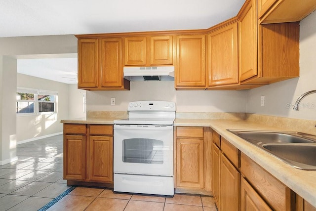 kitchen featuring sink, electric range, and light tile patterned flooring