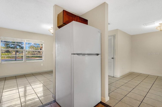 kitchen featuring light tile patterned floors and white refrigerator