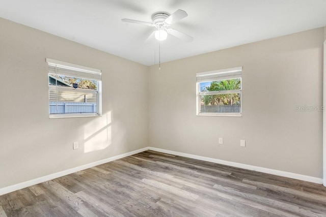 spare room with ceiling fan and wood-type flooring