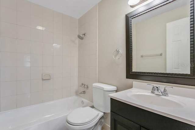 full bathroom featuring vanity, tiled shower / bath combo, and toilet