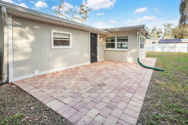 rear view of property featuring a yard and a patio area