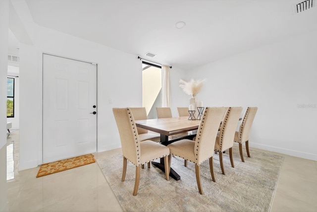 dining space featuring light tile patterned flooring