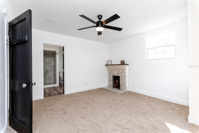 unfurnished living room featuring a fireplace, light colored carpet, and ceiling fan