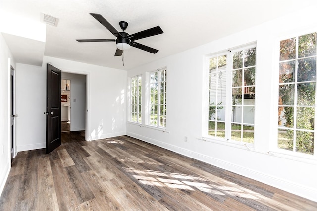 spare room featuring ceiling fan and dark wood-type flooring