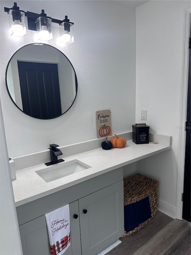 bathroom with hardwood / wood-style floors and vanity