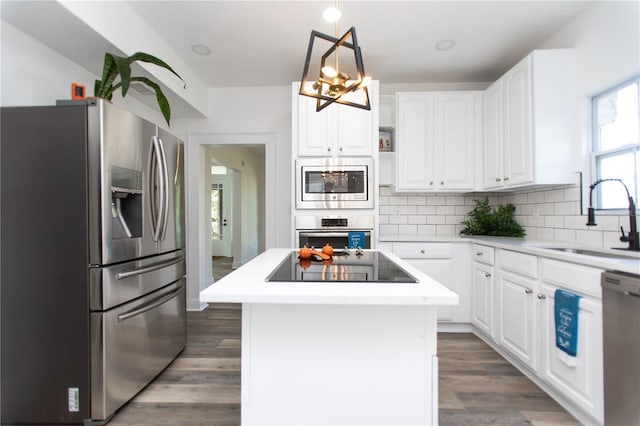 kitchen featuring white cabinets, a kitchen island, and stainless steel appliances