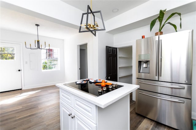 kitchen featuring stainless steel fridge with ice dispenser, decorative light fixtures, white cabinetry, and black electric stovetop