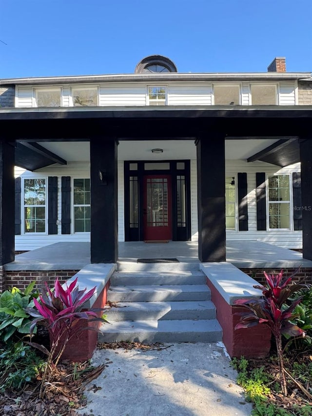 entrance to property featuring a porch