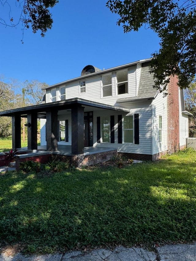 view of front of property with a porch and a front lawn