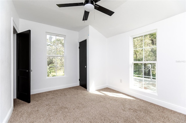 unfurnished bedroom with multiple windows, ceiling fan, and light carpet