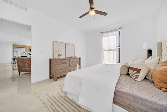 bedroom with ceiling fan and stainless steel refrigerator