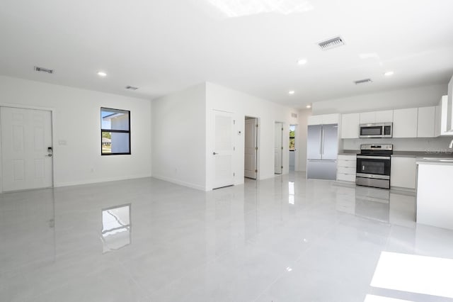 kitchen with visible vents, appliances with stainless steel finishes, and white cabinetry