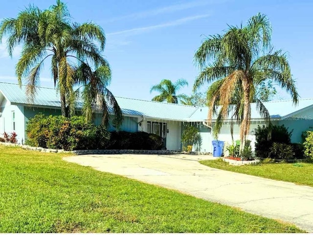 ranch-style home featuring a front yard