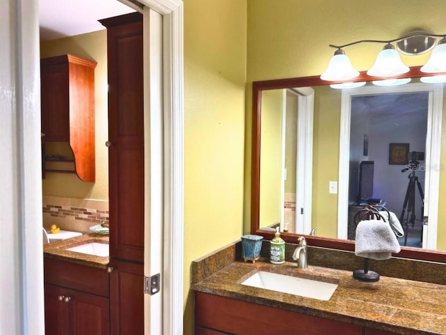 bathroom featuring vanity and backsplash