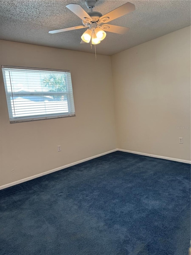 carpeted spare room featuring ceiling fan and a textured ceiling