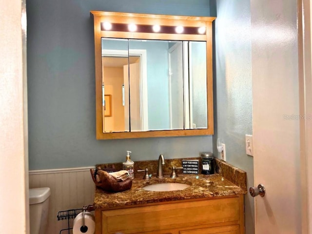 bathroom featuring vanity and toilet