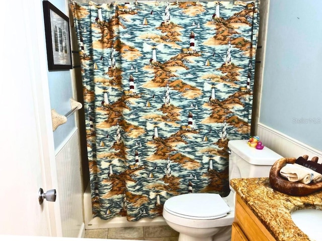 bathroom featuring vanity, toilet, and tile patterned flooring