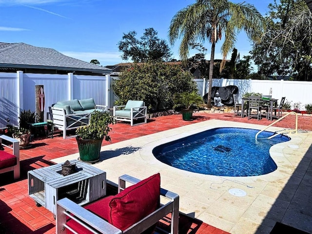 view of pool featuring area for grilling, an outdoor living space with a fire pit, and a patio area