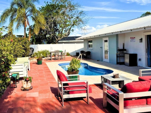 view of pool featuring an outdoor living space and a patio area