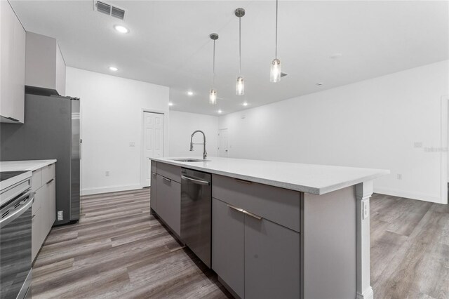 kitchen with gray cabinets, dishwasher, decorative light fixtures, and sink