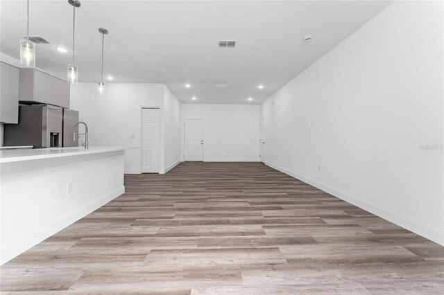 interior space featuring sink and light hardwood / wood-style flooring