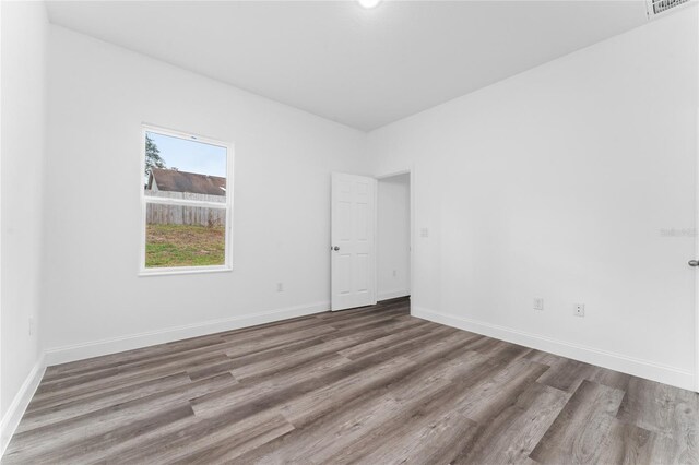 empty room with wood-type flooring