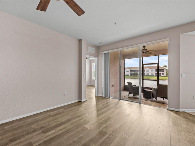 empty room with wood-type flooring and ceiling fan