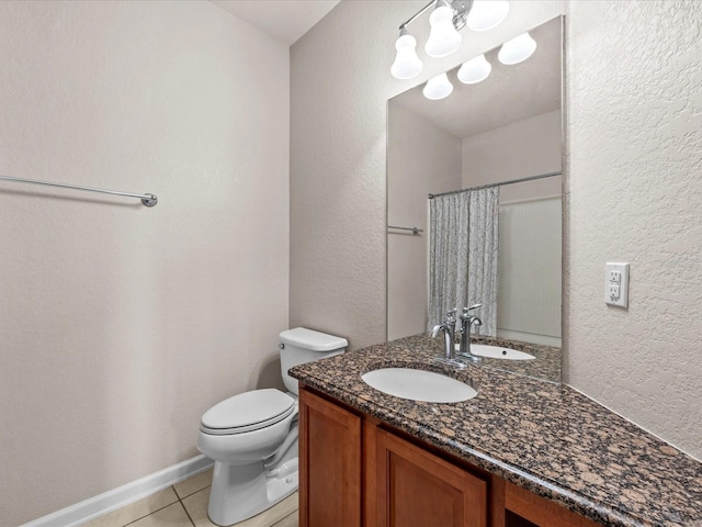 bathroom featuring tile patterned flooring, vanity, a shower with shower curtain, and toilet