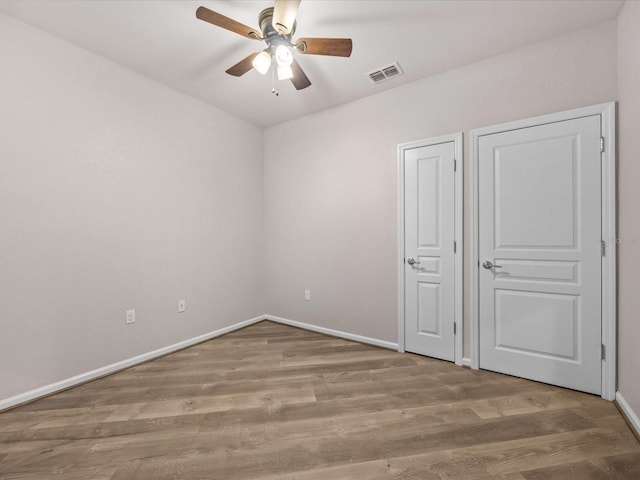 unfurnished bedroom with wood-type flooring and ceiling fan