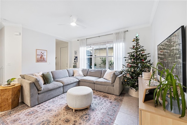 tiled living room featuring ceiling fan and ornamental molding