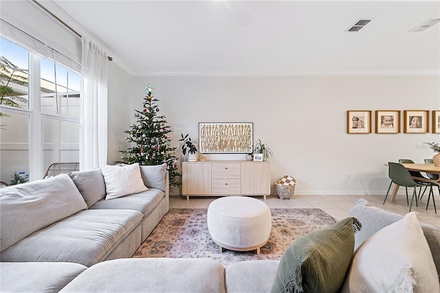 living room with light tile patterned floors and ornamental molding