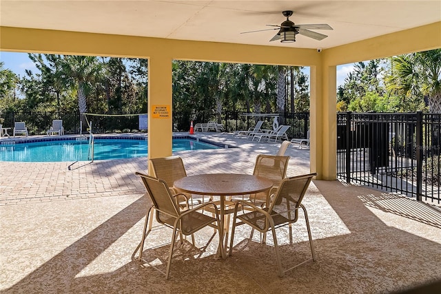 view of pool with a patio and ceiling fan