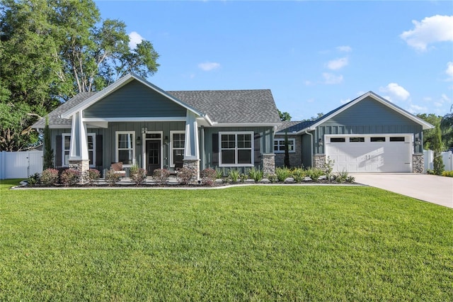 craftsman-style house featuring a porch, a garage, and a front yard