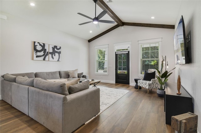 living room featuring dark hardwood / wood-style flooring, vaulted ceiling with beams, and ceiling fan