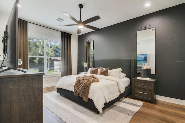 bedroom featuring hardwood / wood-style flooring and ceiling fan