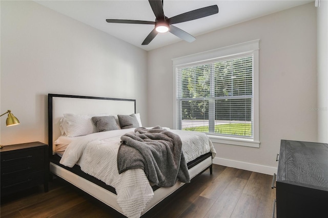 bedroom with ceiling fan and dark hardwood / wood-style floors