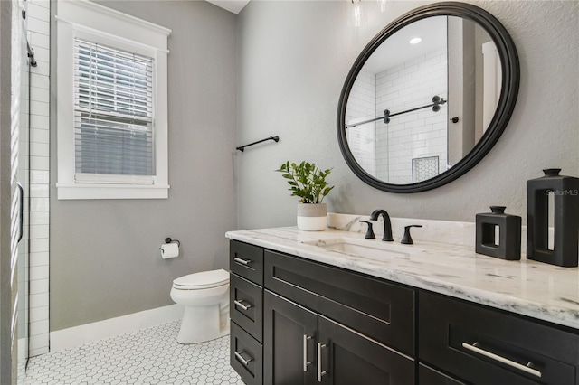 bathroom with a shower, tile patterned flooring, vanity, and toilet