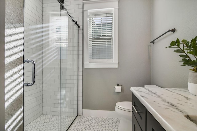 bathroom with toilet, vanity, tile patterned floors, and an enclosed shower