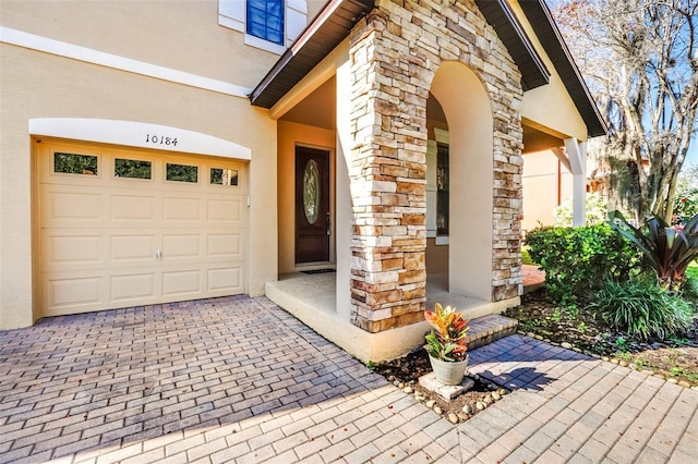 doorway to property with a garage