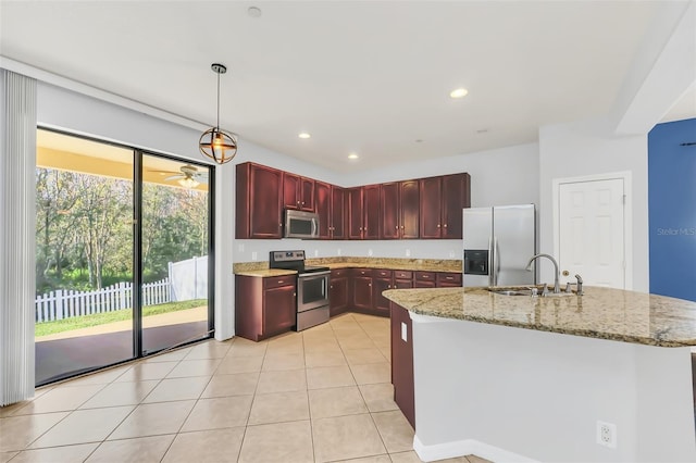 kitchen with light stone countertops, decorative light fixtures, stainless steel appliances, ceiling fan, and sink