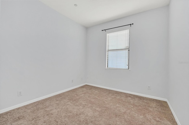 unfurnished room featuring light carpet